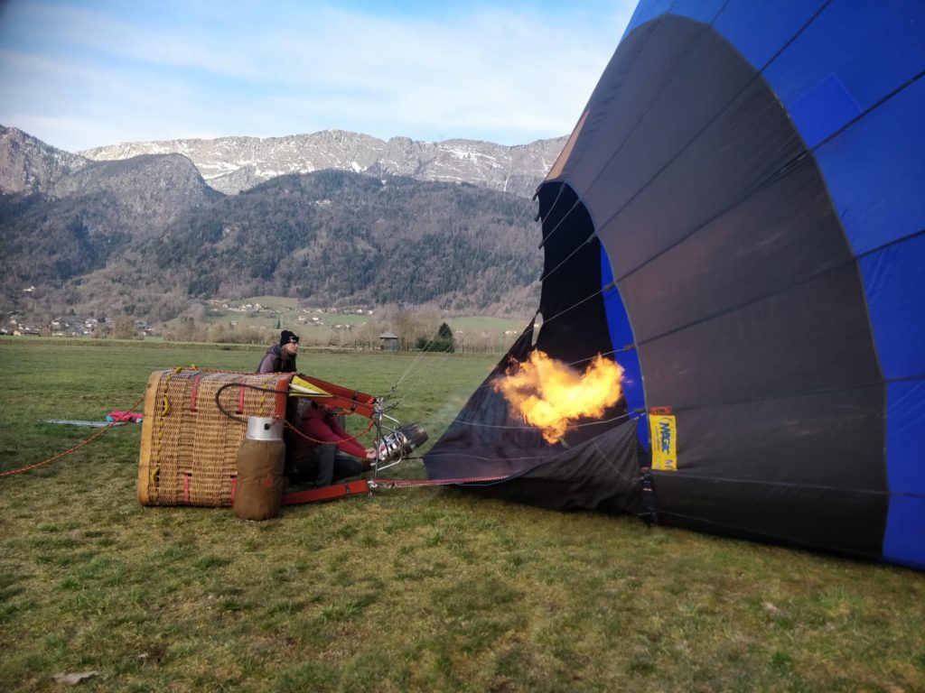 Inflating the hot air balloon at the foot of the mountains