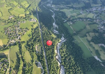 Une montgolfière rouge au-dessus de la vallée, vue d'en haut