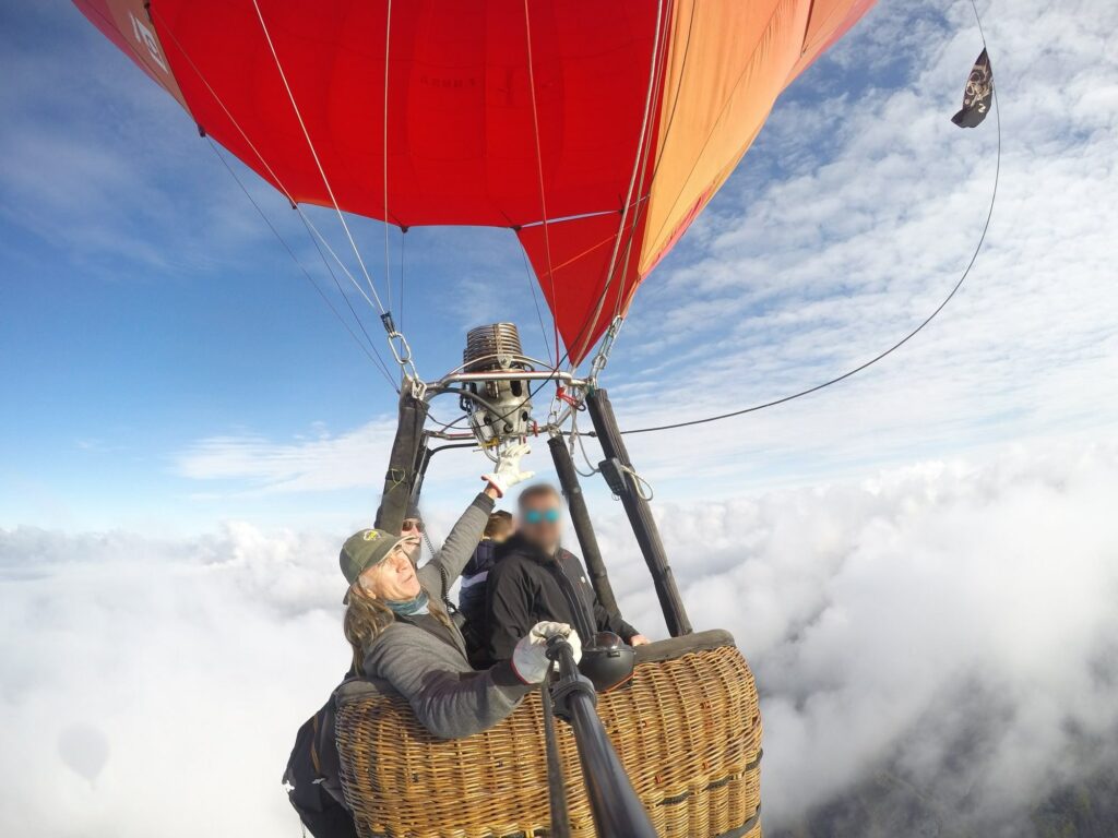 Passagers en coupe-vent dans la nacelle au-dessus des nuages : que mettre pour un vol en montgolfière